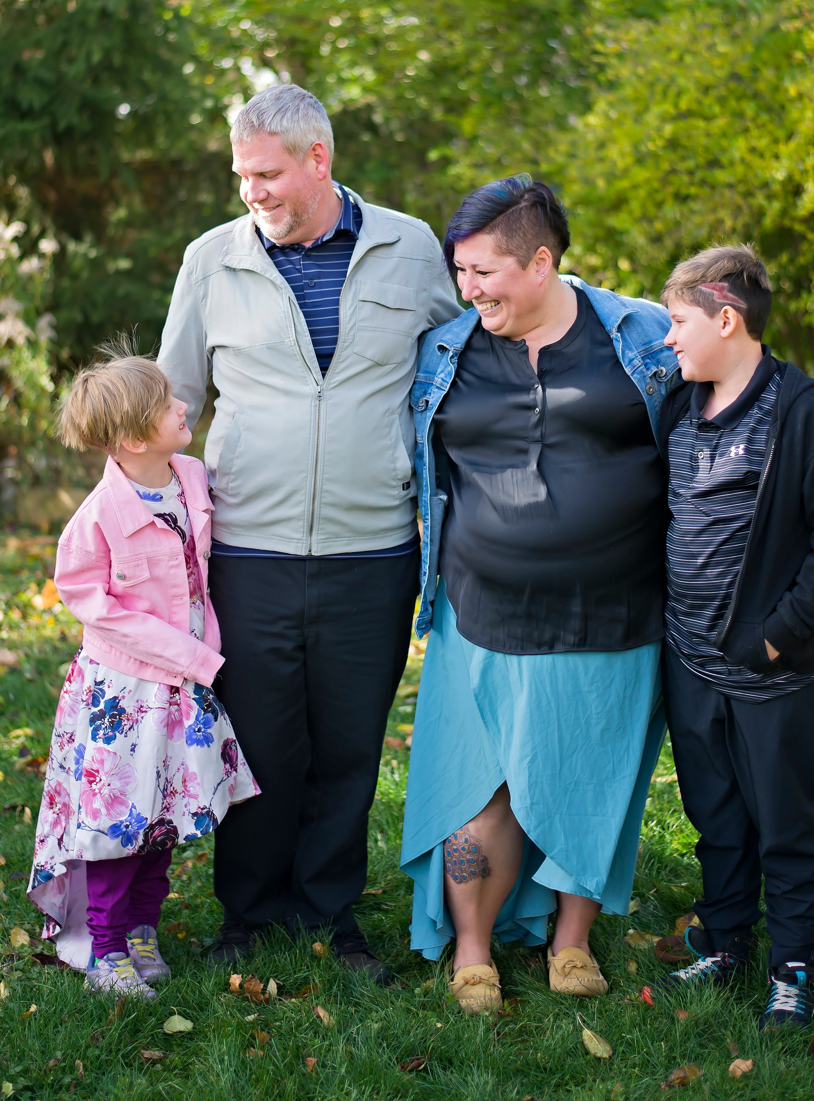 Kathleen’s family standing side-by-side, smiling at each other.